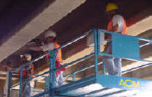 Working at night drilling holes every 2 feet to hold up the pigeon exclusion netting