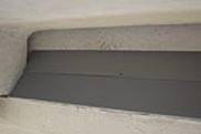 Parking garage ledge with bird slide keeps pigeons from nesting
